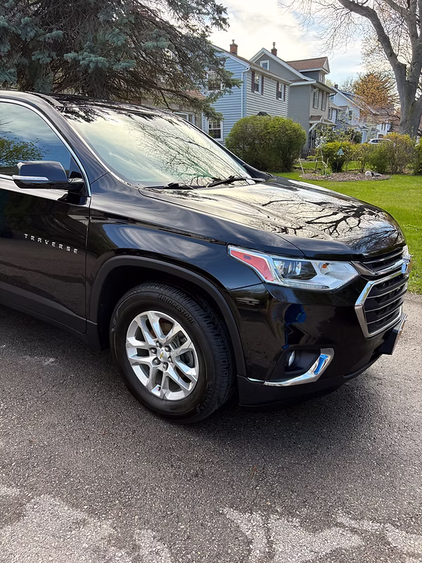 SUV covered in snow foam during a mobile exterior hand wash in a Rochester, NY driveway